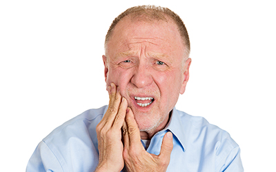 An older man with a toothache